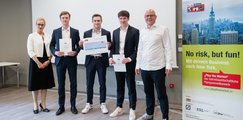 Siegerteam Platz 1 "MPF" vom Deutschhaus Gymnasium in Würzburg hält Hauptreis einen Scheck für eine einwöchige Sprachreise nach New York hoch. Mit auf dem Foto sind Frau Sandra Stenger aus dem bbw e.V. und Herr Sascha Schmidt von den ESL Sprachreisen